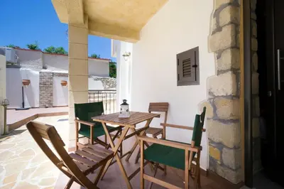 a table and chairs on the patio of a house at Kyriaki's Traditional House in Galatás