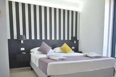 a bedroom with a large bed with colorful pillows at Galini Sea View in Agia Marina Nea Kydonias
