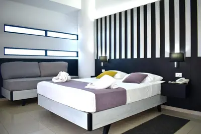 a bedroom with a bed with towels on it at Galini Sea View in Agia Marina Nea Kydonias