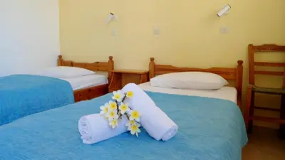a room with two beds with flowers on them at Katerina Palaiochora in Palaiochóra