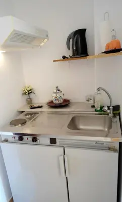 a kitchen counter with a sink and a microwave at Katerina Palaiochora in Palaiochóra
