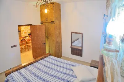 a bedroom with a bed and a door and a mirror at Nemesis in Plátanos