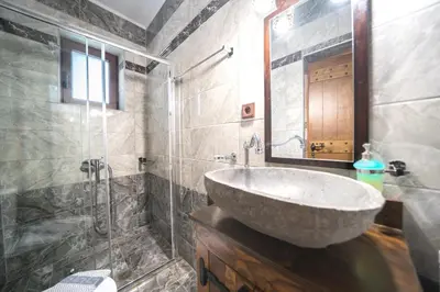 a bathroom with a sink and a glass shower at Nemesis in Plátanos