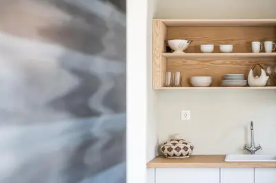 a kitchen with a shelf with dishes and a sink at Artemide city places-Splantzia Square in Chania Town