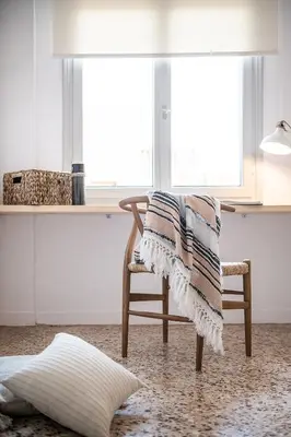 a blanket sitting on a chair in a room at Artemide city places-Splantzia Square in Chania Town