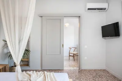 a white room with a bed and a tv at Artemide city places-Splantzia Square in Chania Town