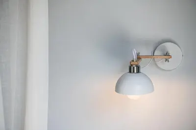 a light on a wall with a white wall at Artemide city places-Splantzia Square in Chania Town