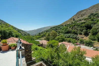 a view of a village with mountains in the background at Dream House in Perivólia