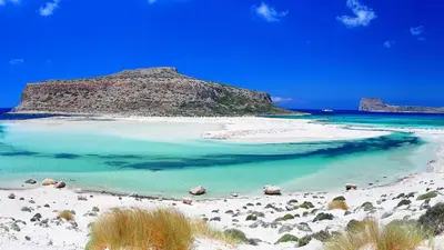 a beach with turquoise water and a mountain at Modi Home in Vrísai