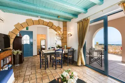 a kitchen and dining room with a table and chairs at Villa Ariadne in Stalos