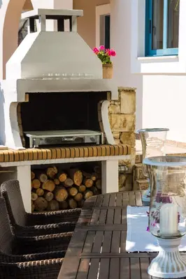 a pizza oven sitting on top of a table at Villa Ariadne in Stalos