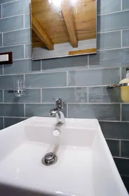 a bathroom with a white sink and a mirror at Kyriaki's Traditional Loft in Galatás