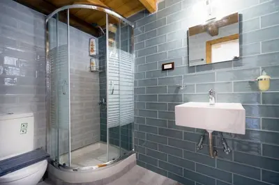 a bathroom with a sink and a shower and a toilet at Kyriaki's Traditional Loft in Galatás