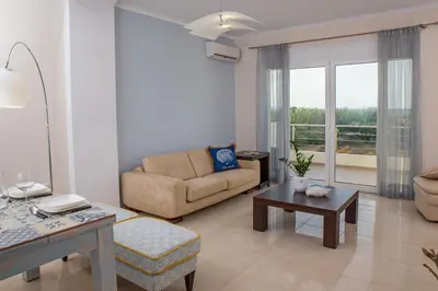 a living room with a couch and a table at Geas House Thalassa in Kolymvari