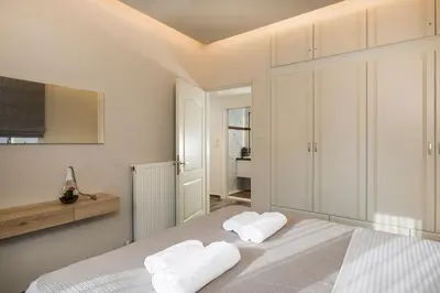 a bedroom with a bed with two towels at Sun Ray Luxury Apartments in Agia Marina Nea Kydonias