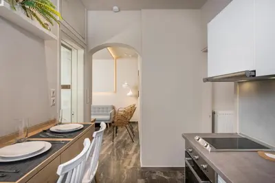 a kitchen with a counter and a table with chairs at Sun Ray Luxury Apartments in Agia Marina Nea Kydonias