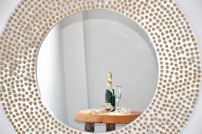 a mirror on a table with a bottle of champagne at Madares Apartments Anopolis in Anopoli Sfakion