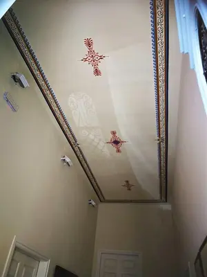 a room with a ceiling with paintings on it at Apollon Hotel in Chania Town