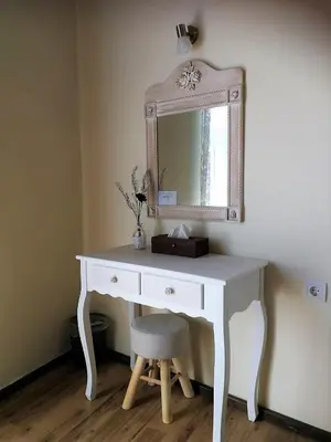 a white desk with a mirror and a stool at Apollon Hotel in Chania Town