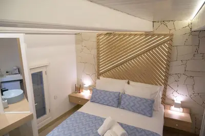 a bedroom with a bed with a wooden headboard at Nine in Chania Town