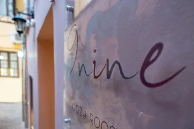 a sign that says newnin on the side of a building at Nine in Chania Town
