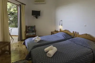 two beds in a bedroom with towels on them at Christiana Apartments in Gerani Chanion