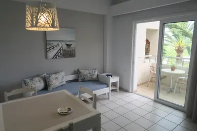a living room with a couch and a table at Maria Suites in Plataniás
