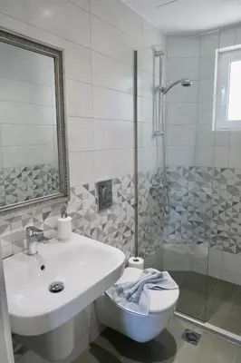 a bathroom with a sink and a toilet and a shower at Maria Suites in Plataniás