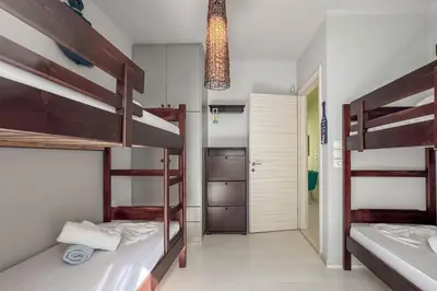 a room with three bunk beds and a hallway at Alisahni Villa & Suite in Kato Daratso