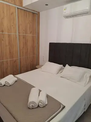 a bedroom with a bed with two towels on it at Parthenon Hotel in Souda
