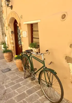 a green bike parked next to a building at Calle Veneziana in Chania Town