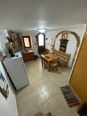 a kitchen and a living room with a table at Calle Veneziana in Chania Town