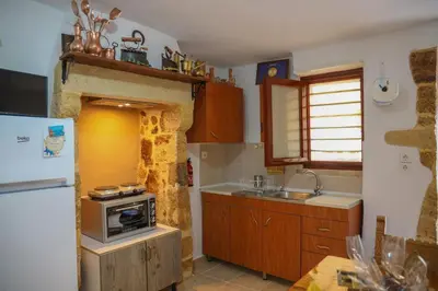 a kitchen with a stove and a sink and a refrigerator at Calle Veneziana in Chania Town
