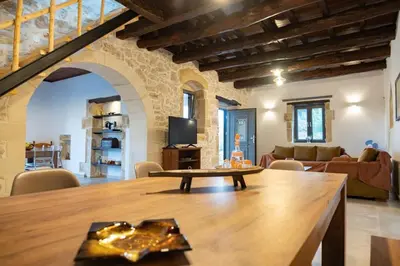 a living room with a table and a couch at Traditional Villa in fres in Frés