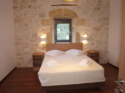 a bedroom with a white bed with two night stands at Traditional Villa in fres in Frés