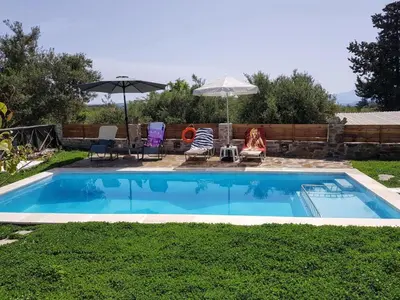 a swimming pool with chairs and umbrellas in a yard at Traditional Villa in fres in Frés