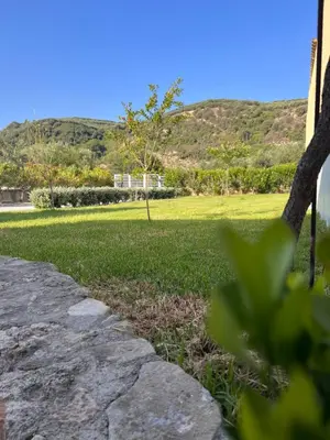 a stone path leading to a park with mountains in the background at Villa Martini in Kissamos