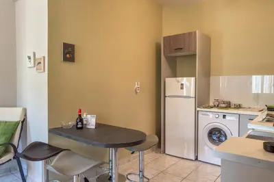 a small kitchen with a table and a refrigerator at Alisahni Home 1 in Kato Daratso