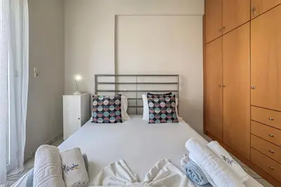 a bedroom with a large white bed with pillows at Alisahni Home 1 in Kato Daratso