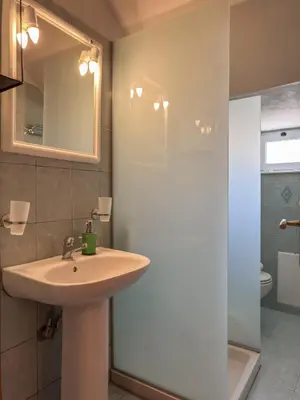 a bathroom with a sink and a shower at Alisahni Home 1 in Kato Daratso