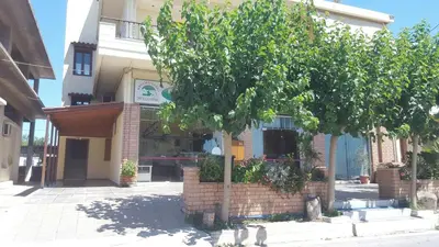 a tree in front of a brick building at Penthouse in Chania Town