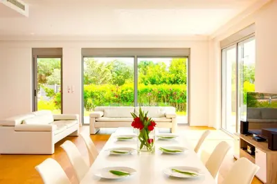 a living room with a white table and chairs at Luxury Villa Stella with private swimming pool in Tersanas