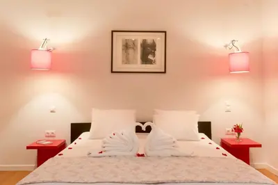a bedroom with a white bed with two night stands at Luxury Villa Stella with private swimming pool in Tersanas