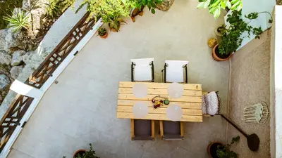 an overhead view of a table and chairs in a garden at Anna's Village House in Perivólia
