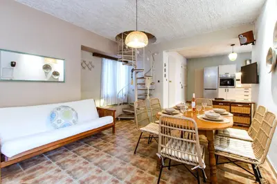 a living room with a table and a couch at Anna's Village House in Perivólia