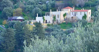 a large white house sitting on top of a hill at Maria Villas in Kissamos