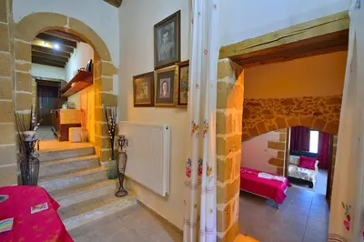 a living room with a staircase and a red couch at Maria Villas in Kissamos