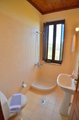 a bathroom with a tub and a sink and a toilet at Maria Villas in Kissamos