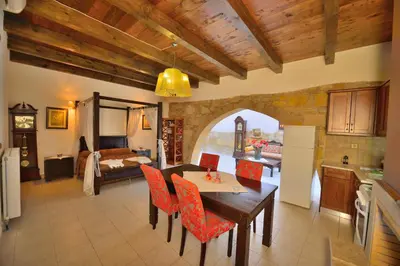 a kitchen and living room with a table and chairs at Maria Villas in Kissamos