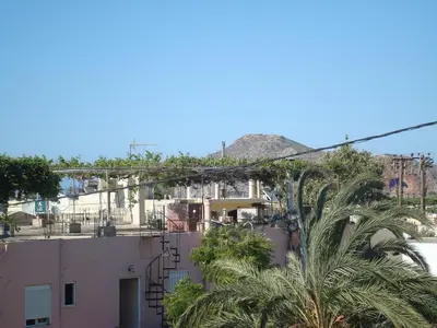 a view of a building with a mountain in the background at Babis Apartments in Plataniás